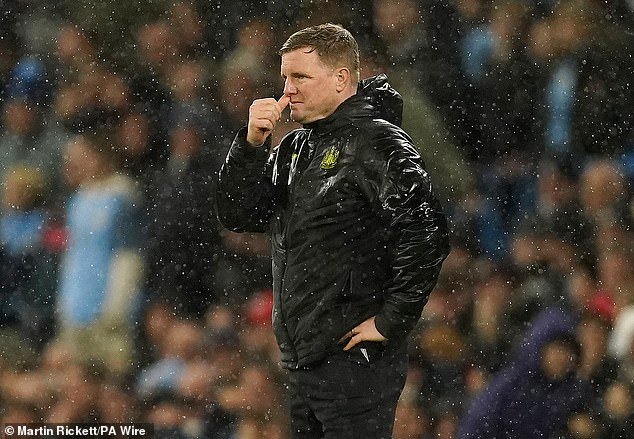 Eddie Howe stands in the rain watching as Manchester City dominate at the Etihad