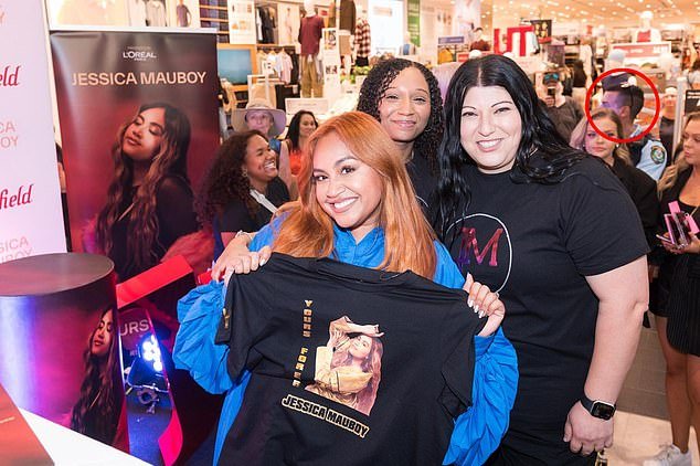Lamarre-Condon is seen in the background of a photo Jessica Mauboy took with fans at Westfield Bondi Junction on February 12
