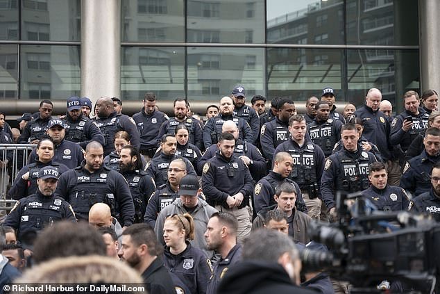 Hundreds of NYPD officers descended on Queens Supreme Court on Wednesday as one of the shooting suspects was indicted on weapons charges