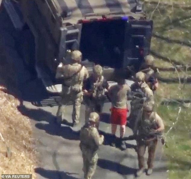 FBI agents arrest Teixeira, a U.S. Air Force National Guard operative, in connection with an investigation into the online leak of classified U.S. documents, outside a home in this still image from a video in North Dighton, Massachusetts, on April 13 2023