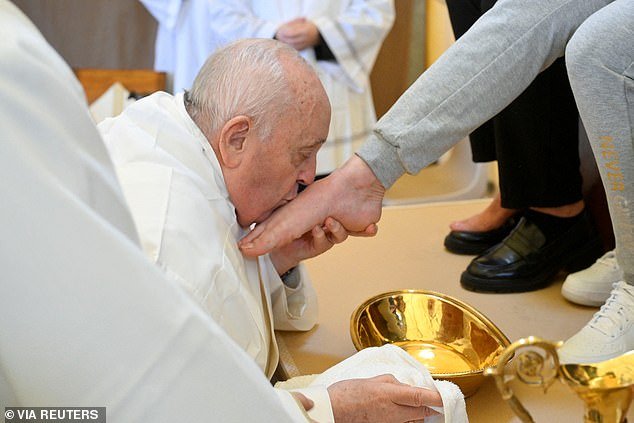 Pope Francis kisses the feet of a prisoner from the women's section of Rebibbia prison during a Holy Thursday ritual
