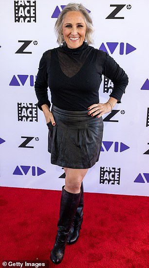 Lake wore a sheer black top that tucked into the waist of a leather miniskirt that stopped a few inches above her knees.
