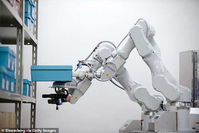 Illustrative image shows a robotic arm in use at a factory in Japan