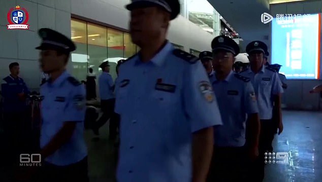 The footage, filmed by a Chinese security agency and obtained by 60 Minutes, shows dozens of Chinese police officers smashing down doors and arresting nearly 80 young male and female alleged cyber scammers in Fiji (pictured)