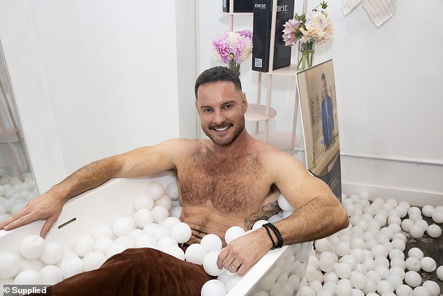 Darren Palmer went shirtless as he smiled for playful photos at a launch party to celebrate his new range with Meir on Monday night
