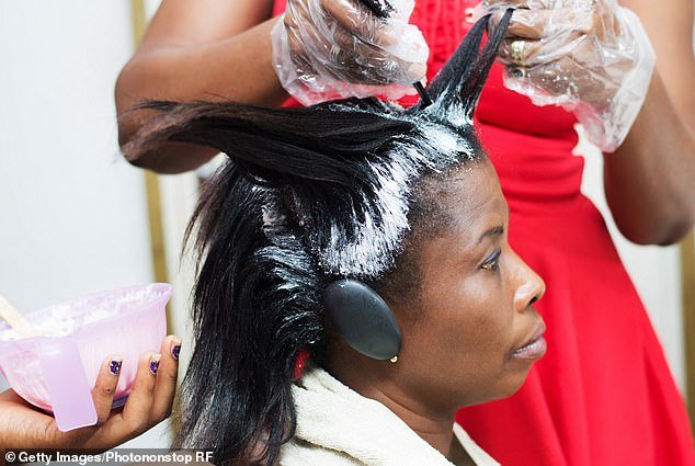 Chemical hair straighteners, typically marketed to black women, break down the protein bonds in curly hair using chemicals known to disrupt the body's hormone balance, leaving hair permanently straight (stock image)