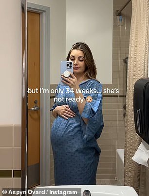 She uploaded a clip filming herself in a hospital gown and typed: 'but I'm only 34 weeks... she's not ready yet'
