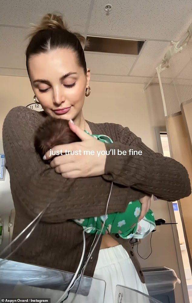 The video jumped to the influencer gently cradling her newborn while still in the hospital, writing, 