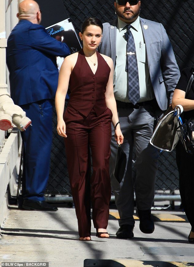 She completed her look with maroon trousers and black heels as she entered the studio