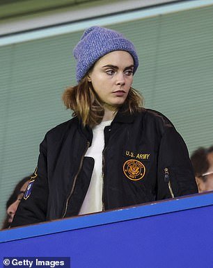 At one point, Cara exchanged her football jersey for a bomber jacket