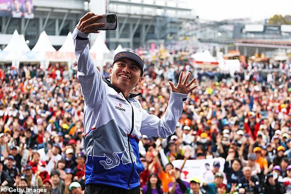 SUZUKA, JAPAN – APRIL 06: Ayumu Iwasa of Japan and Visa Cash App RB take a photo on the fan stage prior to qualifying ahead of the F1 Grand Prix of Japan at Suzuka International Racing Course on April 6, 2024 in Suzuka, Japan.  (Photo by Peter Fox/Getty Images)
