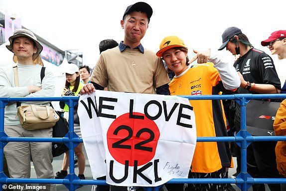 SUZUKA, JAPAN – APRIL 06: A fan of Japan's Yuki Tsunoda and Visa Cash App RB fan shows their support with a flag before qualifying ahead of the F1 Grand Prix of Japan at the Suzuka International Racing Course on April 6, 2024 in Suzuka, Japan.  (Photo by Peter Fox/Getty Images)
