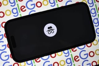 A Google Incognito Mode tab open on a mobile phone, against a multi-colored background consisting of a repeating Google logo.