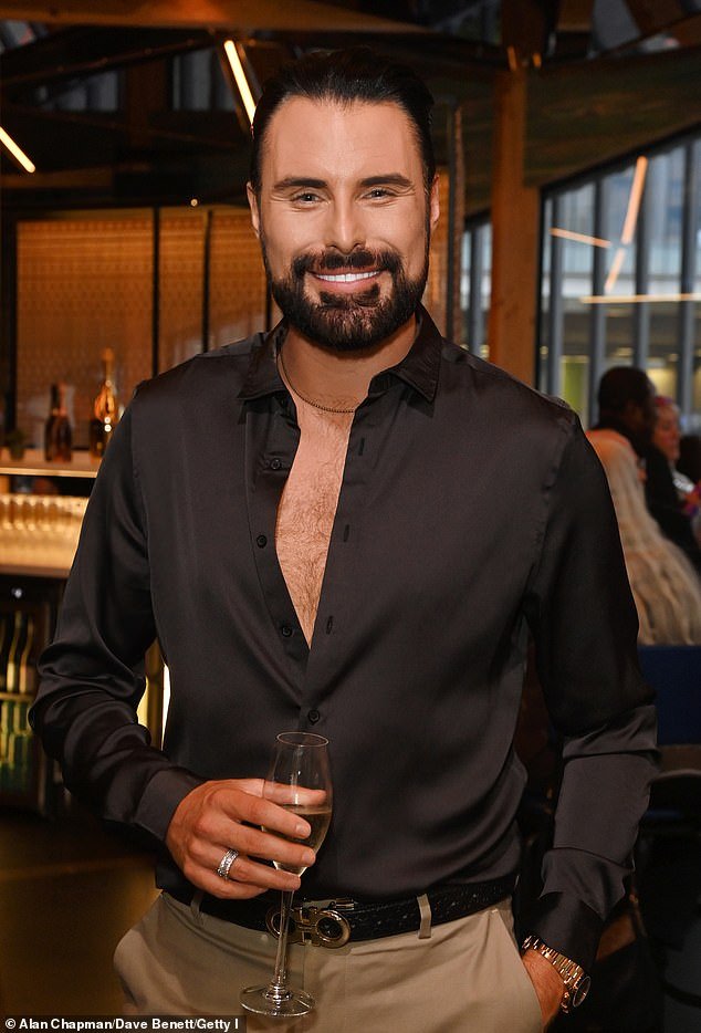 Meanwhile, Rylan teased a glimpse of chest hair in a black shirt that he wore partially unbuttoned with beige chinos.