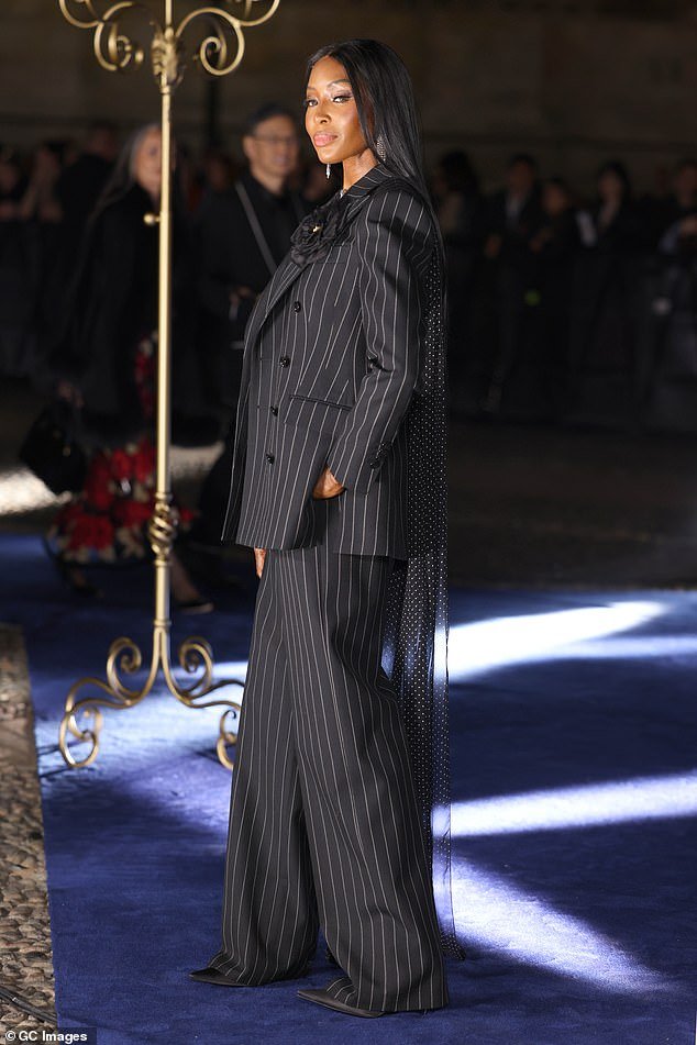 Naomi paired the look with a chic and oversized suit, as she strutted her stuff in a pair of sky-high heels