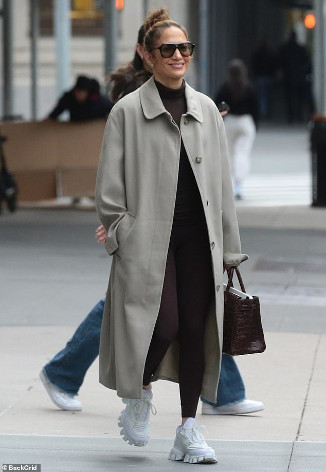 Lopez paired the comfortable outfit with a light gray coat that was unbuttoned at the front to keep her warm in cooler temperatures