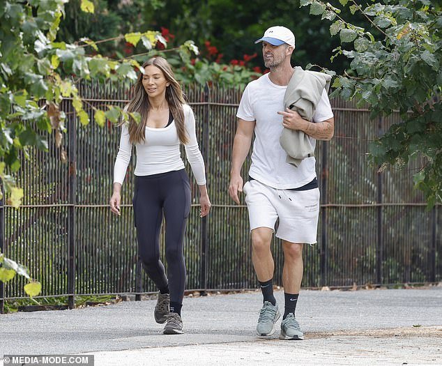 The Henne founder showed off her slim physique in figure-hugging activewear and looked relaxed as she pounded the pavement alongside her model boyfriend