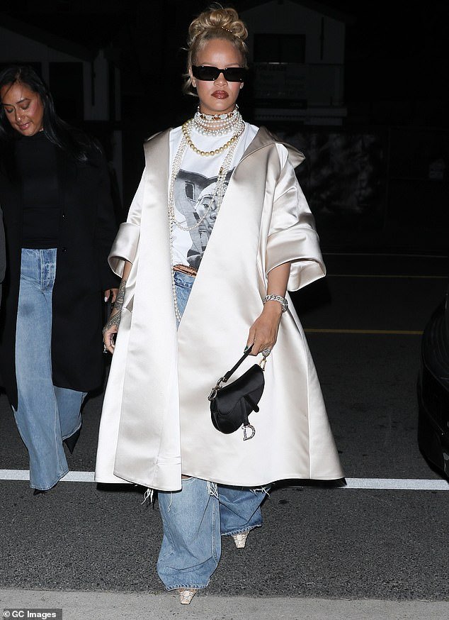Rihanna wore her long blonde locks in a neatly rolled hairstyle and completed her evening outfit with Gucci sunglasses