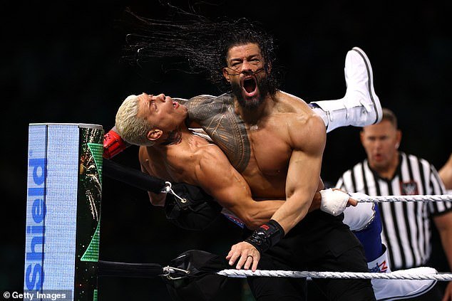 He teamed with WWE Universal Champion Roman Reigns (right) to defeat Cody Rhodes (left) and Seth Rollins