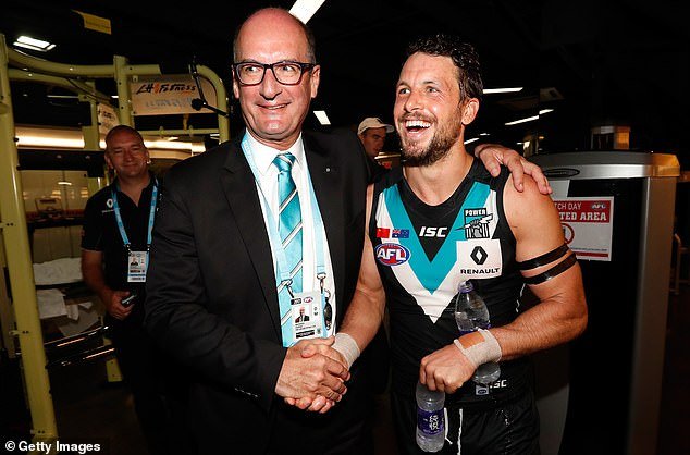 Koch (pictured with Travis Boak after a match in 2017) said Finlayson should be treated the same as Alastair Clarkson, who did not miss a single match after using a homophobic slur against two St Kilda players in pre-season .