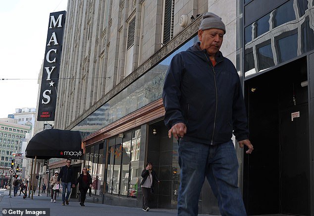 Pedestrians walk past the iconic Macy's flagship store on Union Square in downtown San Francisco, which is about to close.  More than a dozen stores in the once thriving downtown area have closed due to lack of foot traffic, crime and rampant drug use in the area
