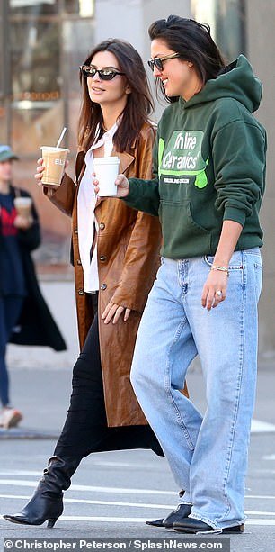 With a bubble tea on hand, the brunette beauty appeared in good spirits as she flashed a pearly white smile as she chatted with her friend.