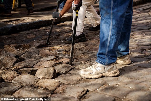 Residents used crowbars to pull up the cobblestones one by one before removing them from the site