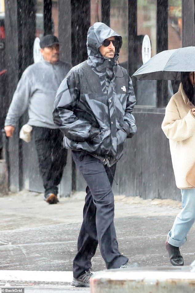 The 49-year-old actor was covered in a gray patterned rain jacket from North Face, with jeans and sunglasses