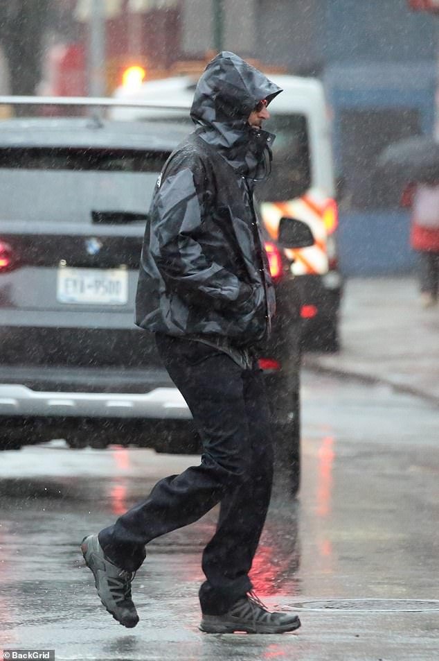 The star ran errands in the Big Apple during the rainstorm without his girlfriend, model Gigi Hadid, 28