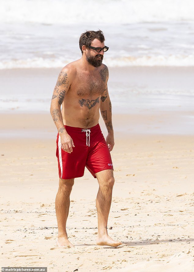Meanwhile, Matty, co-founder of indie fashion label Something Very Special, went shirtless for the outing, wearing nothing but red board shorts and prescription glasses.