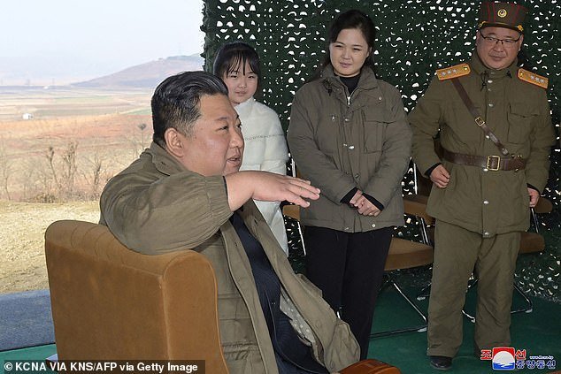 This photo, taken on November 18, 2022 and released by North Korea's official Korean Central News Agency (KCNA), shows North Korean leader Kim Jong Un (left) with his wife Ri Sol Ju (second from right) and daughter Ju Ae (second from left) as they attend the test firing of the new type of intercontinental ballistic missile (ICBM) 'Hwasong Gun 17' in North Korea