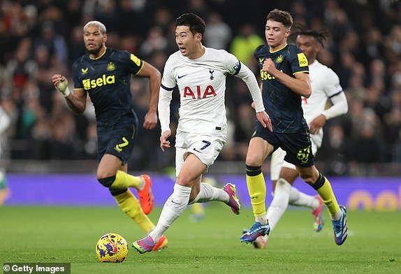 LONDON, ENGLAND – DECEMBER 10: Son Heung-Min of Tottenham Hotspur runs with the ball while under pressure from Joelinton and Lewis Miley of Newcastle United during the Premier League match between Tottenham Hotspur and Newcastle United at the Tottenham Hotspur Stadium on 10 December 2023 in London, England.  (Photo by Julian Finney/Getty Images)