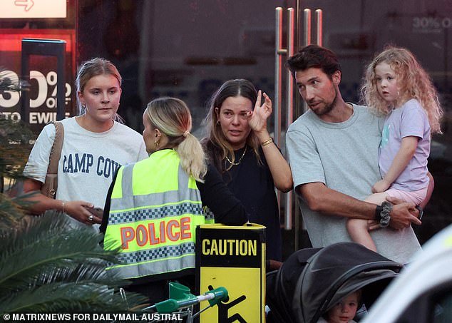 Six innocent shoppers, including the mother of an injured nine-month-old baby, died in the horror knife attack on Saturday afternoon (photo, witnesses speaking to an officer at the scene)