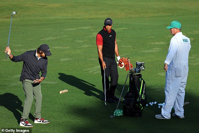 Does Charlie show Dad how it's done?  Tiger Woods watches his son Augusta lash out