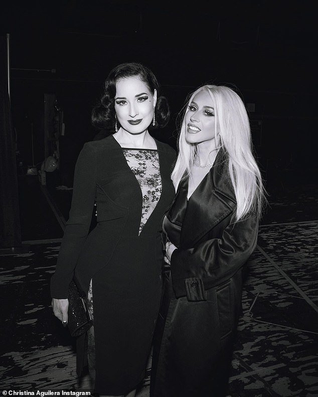 In the next image, Aguilera posed with another famous friend, Dita Von Teese, wearing a stylish black dress