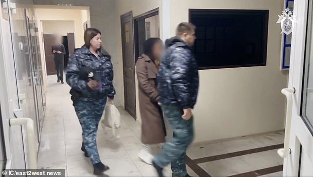 Mironova is led out of a courtroom by guards