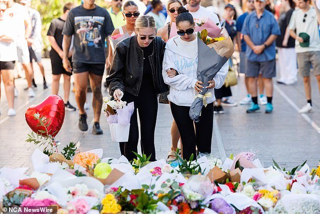 Six innocent shoppers – including five women and one man – were fatally stabbed at Westfield Bondi Junction (pictured, floral tributes from members of the public outside Westfield Bondi Junction)
