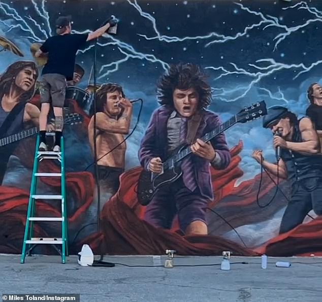 One of the owners of Club 5 Bar claims that Jenner's 28-year-old team ruined their AC/DC mural (pictured) by sticking an 818 decal directly onto it at a pop-up event last week, causing it to was cracked and chipped