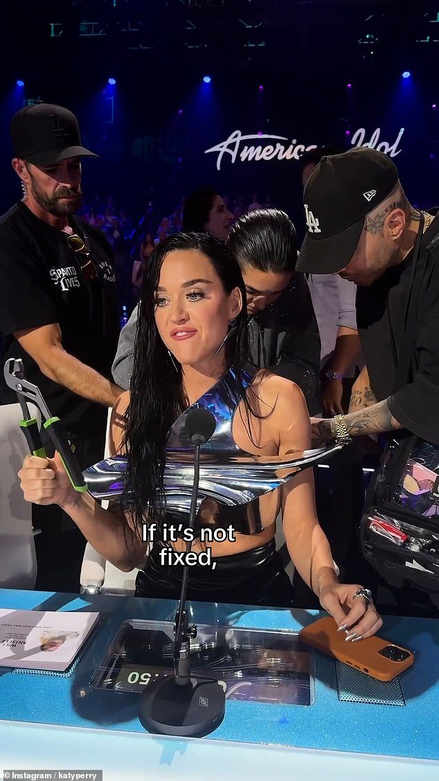 A behind-the-scenes video shared to Instagram showed wardrobe assistants frantically trying to repair the garment as Katy said to the camera: 'I need my top to stay on'