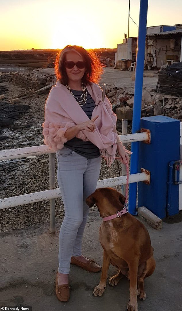 Orla Dargan in Portugal with her rescue dog Henry, who she says was 'killed' amid an ongoing border dispute
