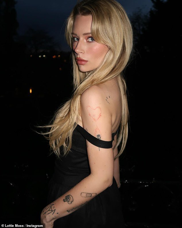 She put on a very pouty show, showing off her gorgeous pink makeup, luminous blonde locks and unique facial tattoo as she posed on her balcony in London.
