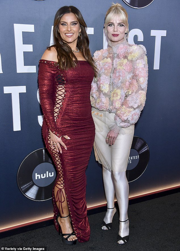 The actress, 30, stunned in a floral jacket paired with a sheer gold skirt and metallic silver tights as she posed with Nelly Furtado on the red carpet at the Egyptian Theater Hollywood