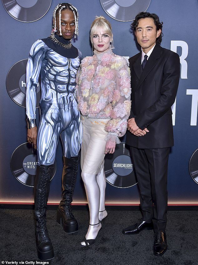 Lucy posed with co-star Austin Crute, who wore a dramatic muscle suit, and Justin H. Min, who wore a smart black suit, and
