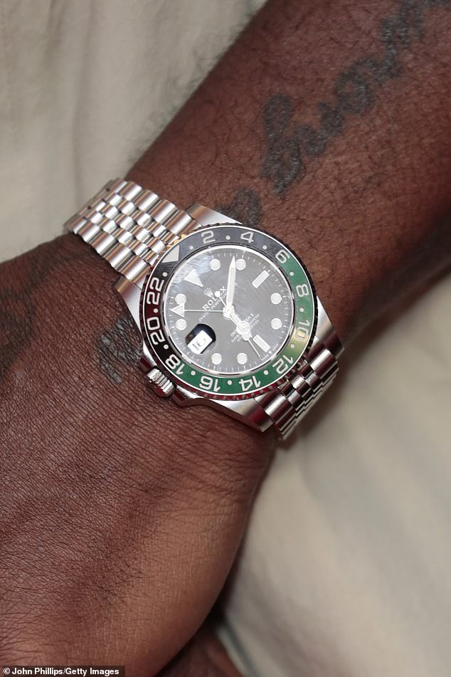 His Rolex is estimated to be worth £9,800