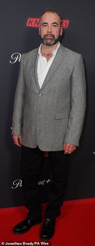 Rory McCann opted for a gray blazer jacket and white shirt