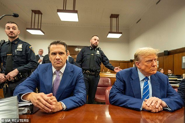 Former US President Donald Trump sits in court with lawyer Todd Blanche on the second day of his trial in Manhattan Criminal Court, New York City, New York, USA April 16, 2024