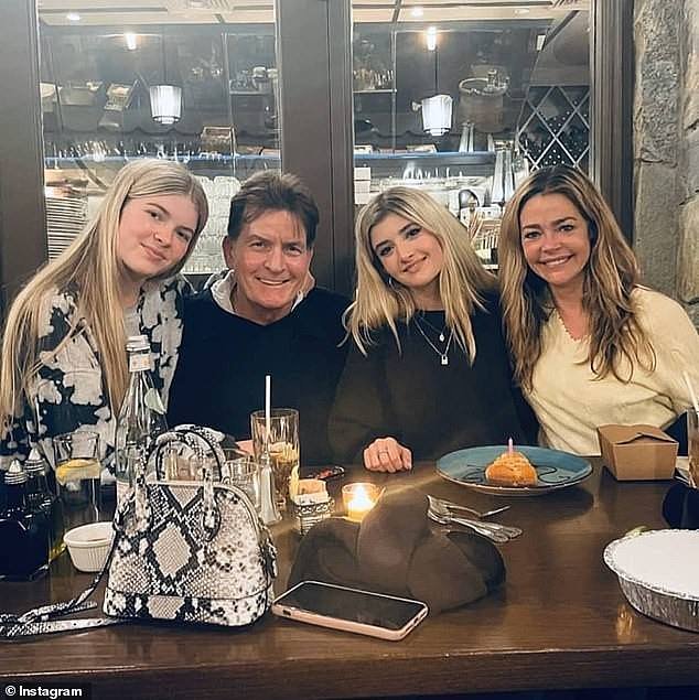 The star sits between her mother Denise Richards and father Charlie Sheen with her sister Lola on the far left