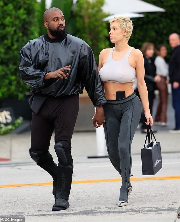 Kanye wore white clothing, as opposed to his usual all-black ensembles.  The couple visited Star Wars Nite and took a ride on the carousel;  pictured in May 2023 in LA