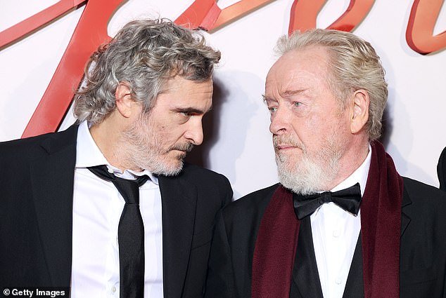 He said, 'I don't know what he was thinking.  I think it's completely his fault and I don't think Ridley Scott is helping him (Phoenix and Scott pictured in November 2023)