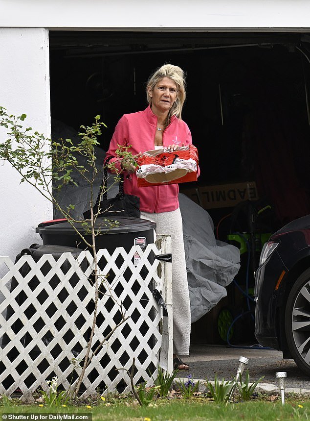 DailyMail.com captured the wife of scandal-hit Democratic Senator Bob outside the house tending plants while wearing yellow Marigold Gloves